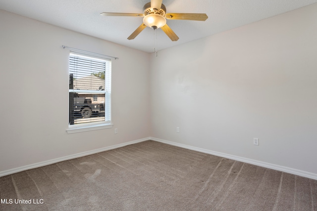 unfurnished room featuring ceiling fan and carpet