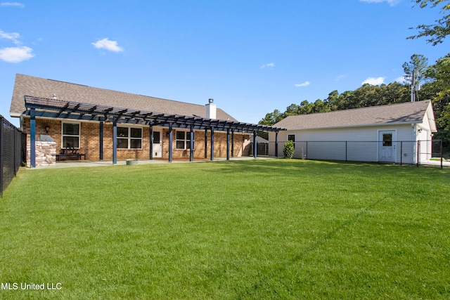 rear view of property featuring a pergola, a patio area, and a yard