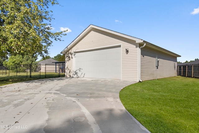 view of side of home with a lawn and a garage