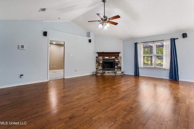 unfurnished living room with lofted ceiling, a fireplace, wood-type flooring, and ceiling fan