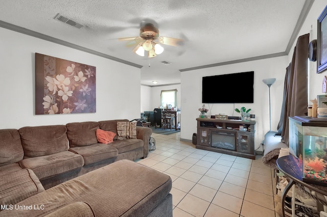 tiled living room with a textured ceiling, ornamental molding, and ceiling fan