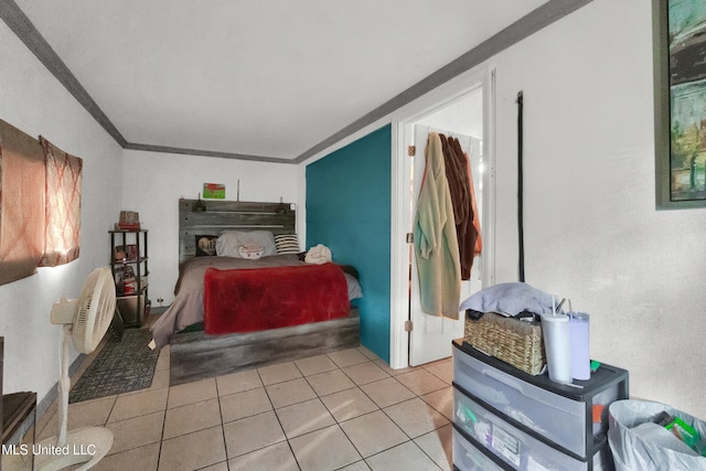 tiled bedroom featuring ornamental molding