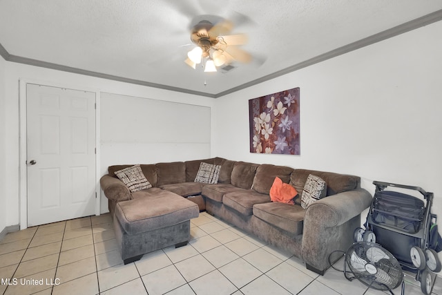 living room with a textured ceiling, ornamental molding, ceiling fan, and light tile patterned floors