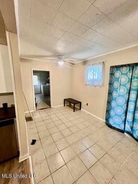 interior space featuring light tile patterned flooring, crown molding, baseboards, and ceiling fan