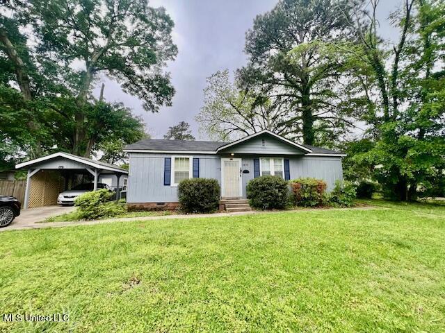 ranch-style house with a carport, crawl space, a front lawn, and fence