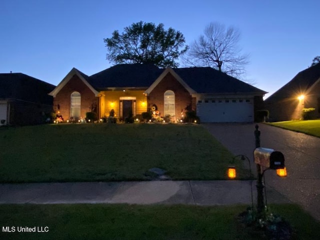 7741 Meadow Ridge Ln, Olive Branch, MS 38654 - ranch-style home with a front yard, an attached garage, and driveway