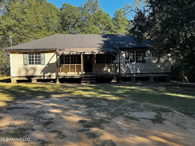 view of front of home featuring a front yard and a wooden deck