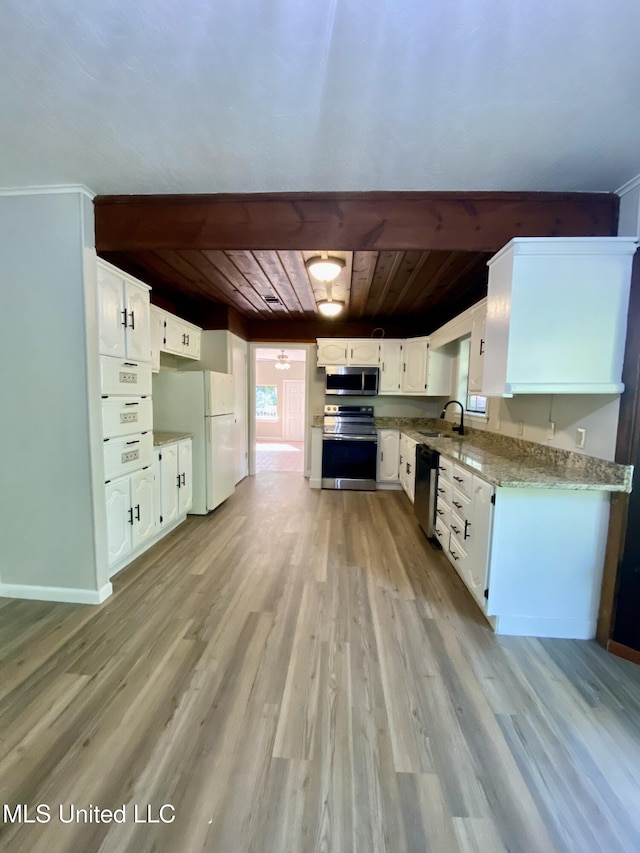 kitchen with a sink, appliances with stainless steel finishes, plenty of natural light, and wood ceiling
