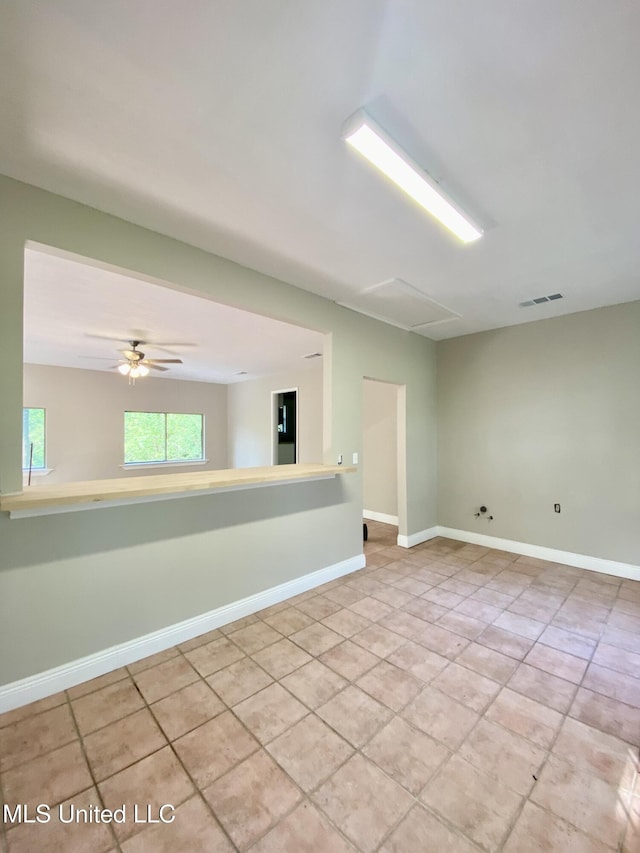 spare room with visible vents, baseboards, ceiling fan, and light tile patterned floors
