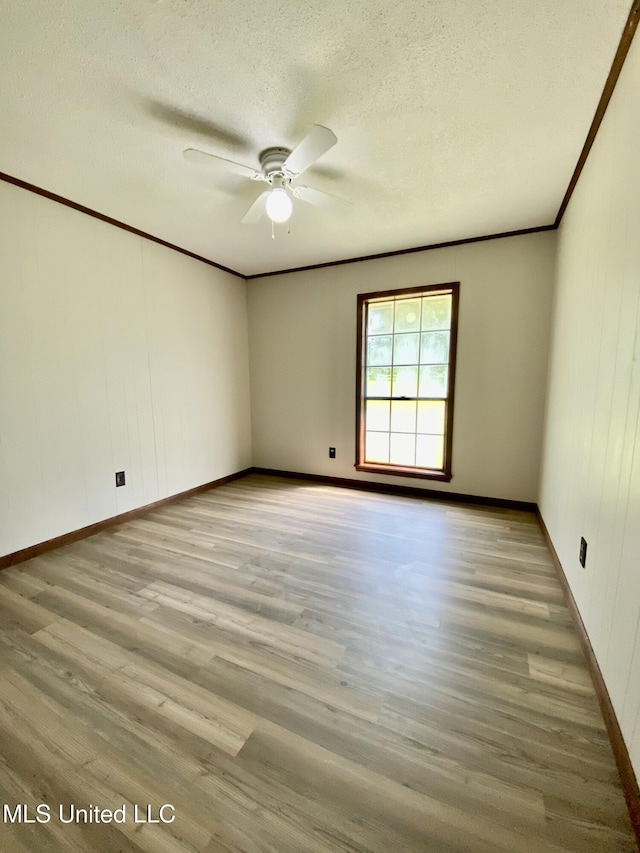 unfurnished room featuring crown molding, a textured ceiling, ceiling fan, and wood finished floors
