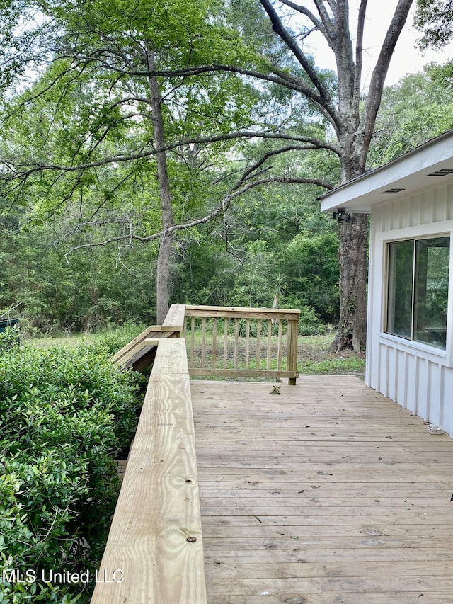 wooden deck with a wooded view