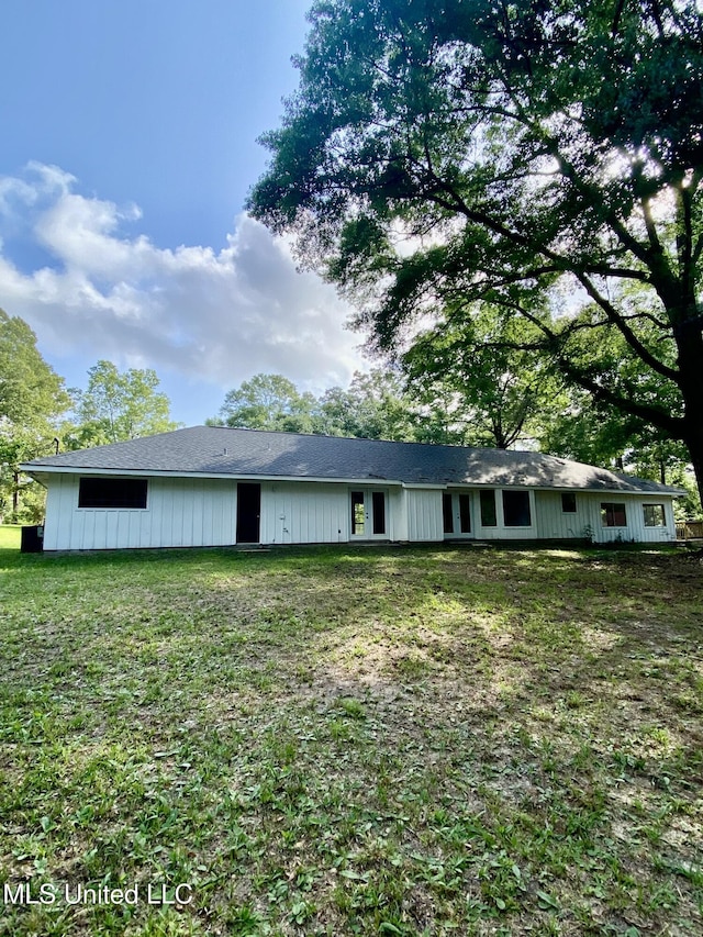 back of house with a lawn