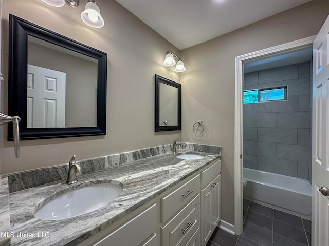 bathroom featuring vanity, tiled shower / bath combo, and tile patterned floors