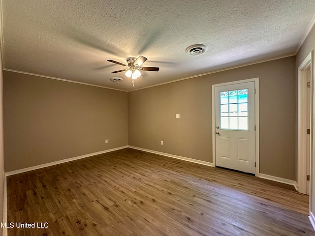 interior space with crown molding, hardwood / wood-style flooring, a textured ceiling, and ceiling fan