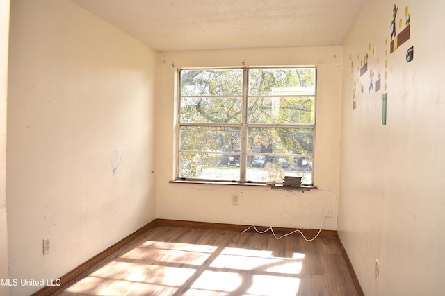 2201 15th Ave, Gulfport, MS 39501 - spare room featuring wood finished floors, healthy amount of natural light, and baseboards