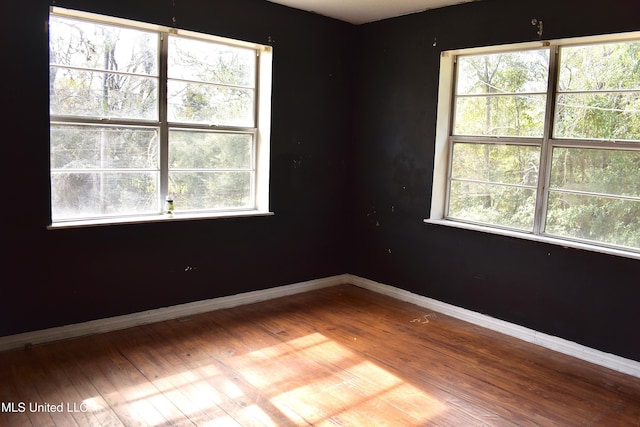 2201 15th Ave, Gulfport, MS 39501 - unfurnished room featuring baseboards, plenty of natural light, and wood finished floors