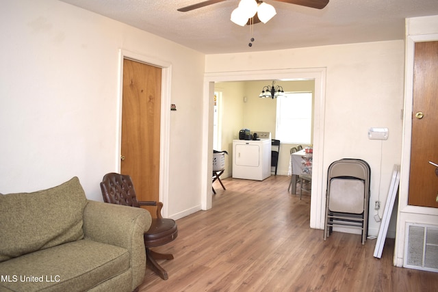 2201 15th Ave, Gulfport, MS 39501 - living room with ceiling fan, wood finished floors, washing machine and dryer, and baseboards