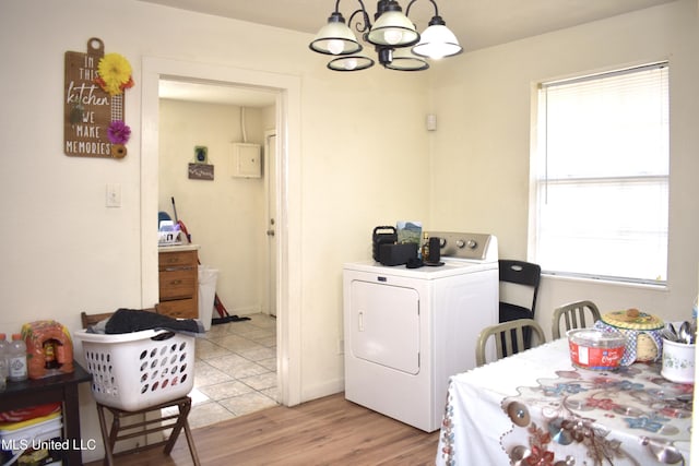 2201 15th Ave, Gulfport, MS 39501 - dining space featuring washer / clothes dryer, a chandelier, healthy amount of natural light, and light wood finished floors