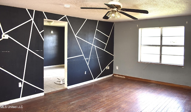 2201 15th Ave, Gulfport, MS 39501 - unfurnished bedroom with wood-type flooring, a textured ceiling, and baseboards
