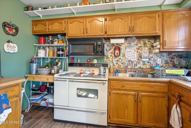 kitchen featuring sink, double oven range, and dark wood-type flooring