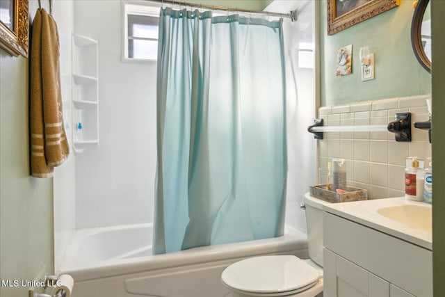 full bathroom with vanity, toilet, tile walls, and shower / bathtub combination with curtain