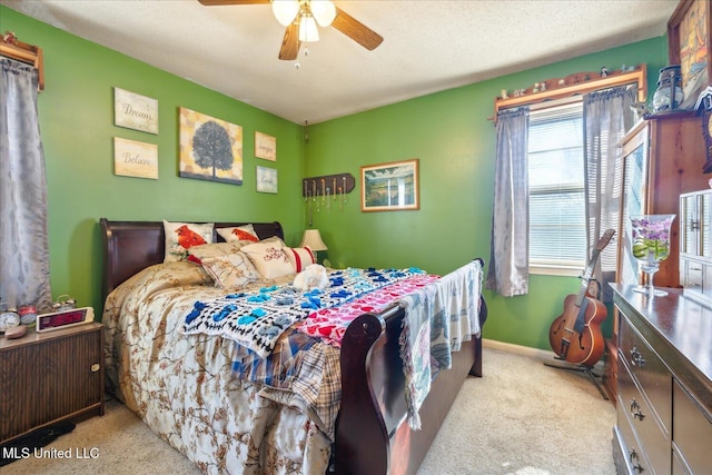 carpeted bedroom with a textured ceiling and ceiling fan