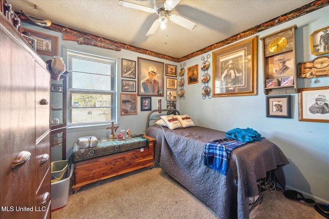 carpeted bedroom with a textured ceiling and ceiling fan