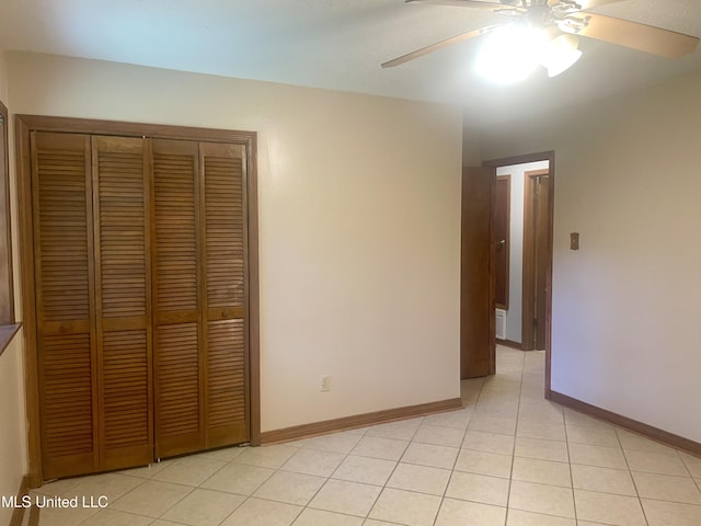 2909 Pimlico Dr, Ocean Springs, MS 39564 - unfurnished bedroom featuring a closet, light tile patterned floors, a ceiling fan, and baseboards