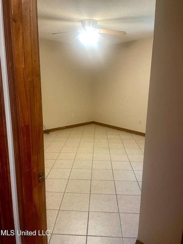 2909 Pimlico Dr, Ocean Springs, MS 39564 - spare room with a ceiling fan, light tile patterned flooring, a textured ceiling, and baseboards