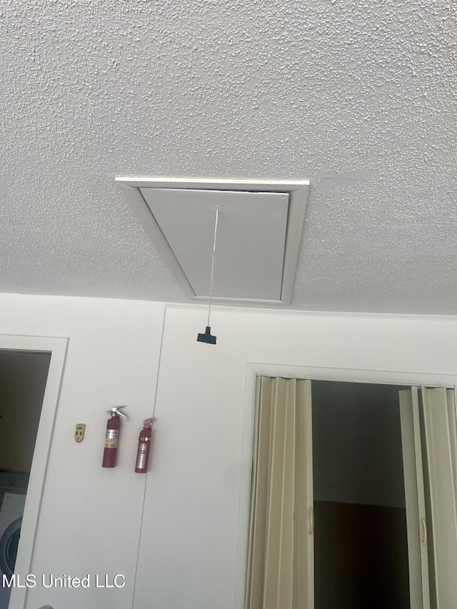 2909 Pimlico Dr, Ocean Springs, MS 39564 - detailed view of a fire extinguisher and washer / clothes dryer