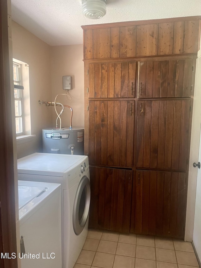 2909 Pimlico Dr, Ocean Springs, MS 39564 - laundry area featuring cabinet space, gas water heater, light tile patterned floors, and a textured ceiling