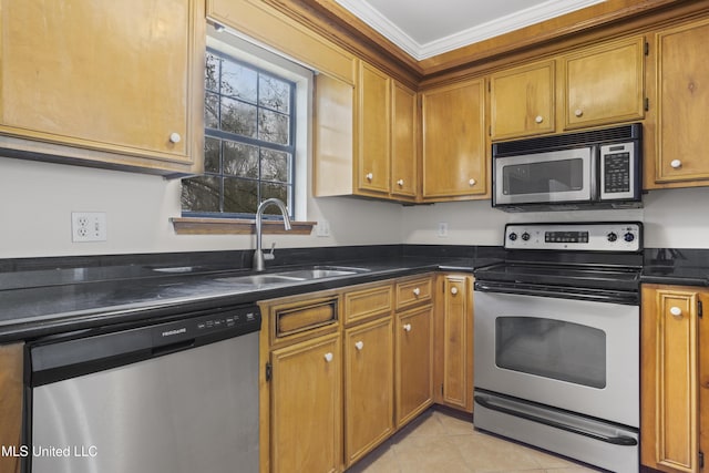 kitchen featuring brown cabinetry, ornamental molding, a sink, appliances with stainless steel finishes, and dark countertops