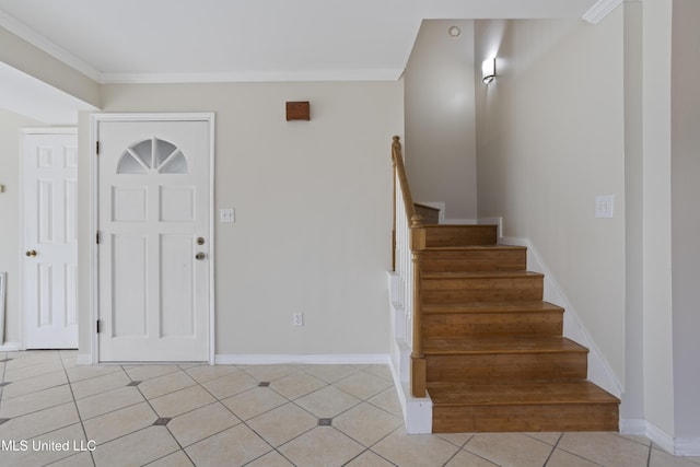 entrance foyer featuring stairs, crown molding, light tile patterned floors, and baseboards