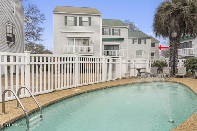 view of swimming pool with a fenced in pool and fence