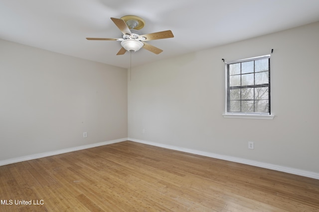 empty room featuring baseboards, light wood finished floors, and ceiling fan