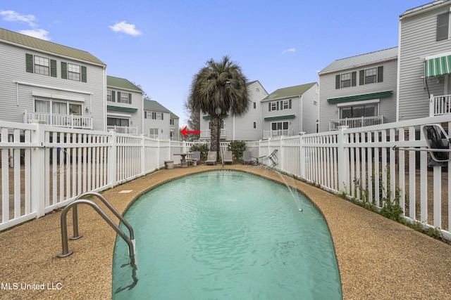 view of swimming pool featuring a fenced in pool, a fenced backyard, and a residential view