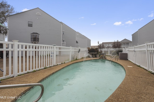 view of pool featuring central AC unit, a fenced in pool, and a fenced backyard