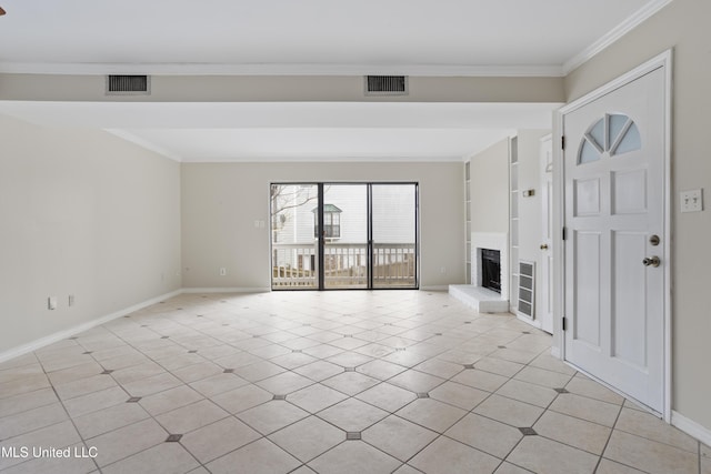 unfurnished living room featuring built in features, visible vents, ornamental molding, and a fireplace