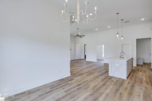 kitchen with visible vents, a ceiling fan, open floor plan, light countertops, and light wood-type flooring