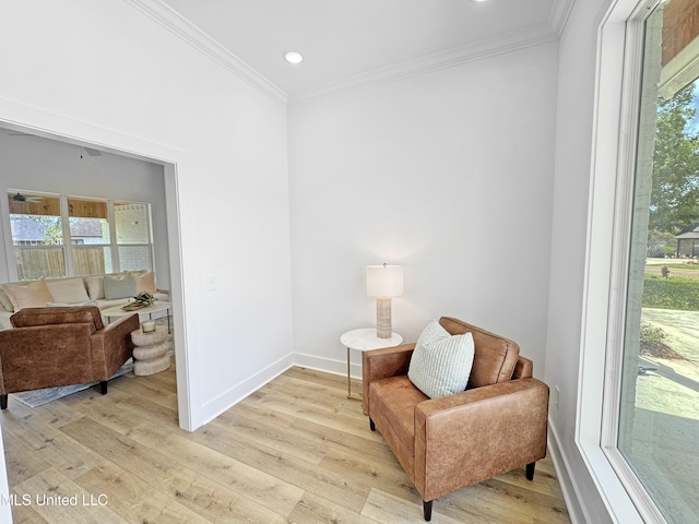 sitting room featuring crown molding, light wood finished floors, and plenty of natural light