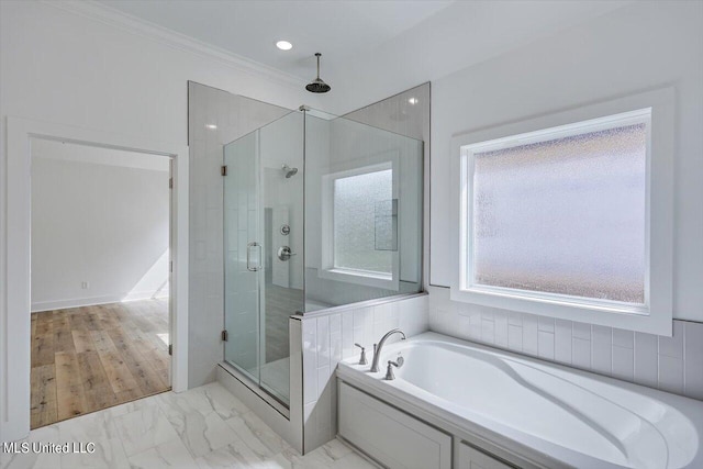 bathroom with marble finish floor, a garden tub, crown molding, and a shower stall