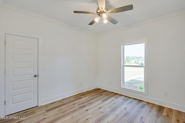 empty room featuring ornamental molding, light wood-style floors, baseboards, and ceiling fan