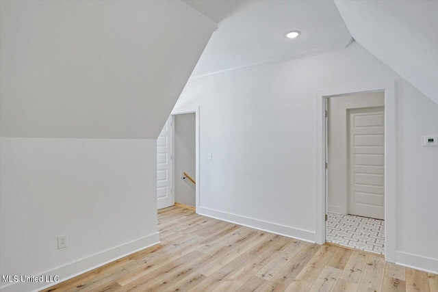 additional living space featuring recessed lighting, lofted ceiling, baseboards, and wood finished floors