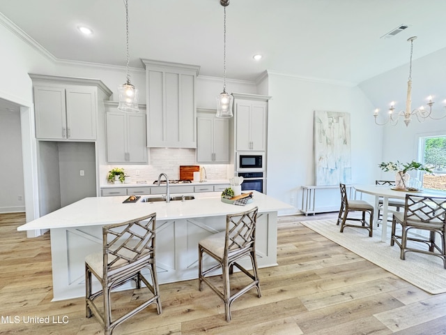 kitchen featuring oven, visible vents, backsplash, black microwave, and light countertops