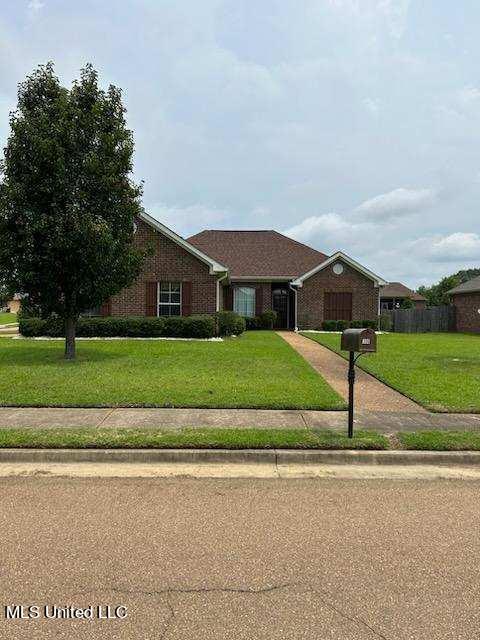 ranch-style home with a front lawn