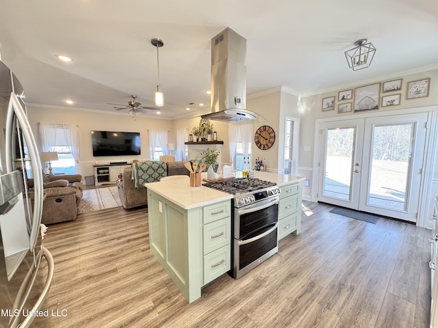 kitchen with island range hood, hanging light fixtures, a kitchen island, appliances with stainless steel finishes, and ceiling fan