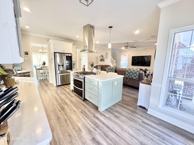 kitchen with island range hood, decorative light fixtures, stainless steel appliances, a kitchen island, and white cabinets