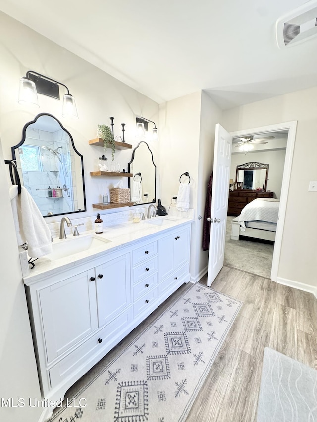 bathroom featuring ceiling fan, hardwood / wood-style floors, and vanity