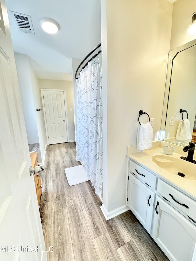 bathroom featuring hardwood / wood-style flooring and vanity