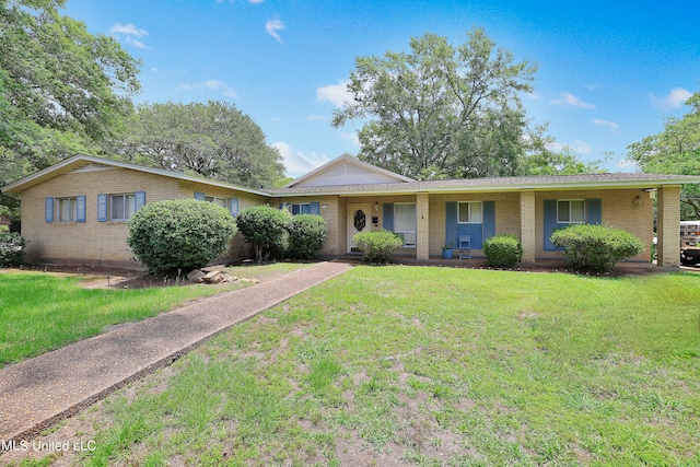 ranch-style home featuring a front yard and covered porch